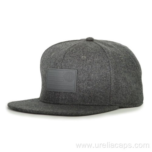 Woolen snapback cap with rubber badge